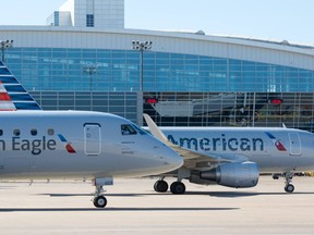Flights operated by American Airline affiliate Envoy Air appear on a tarmac.