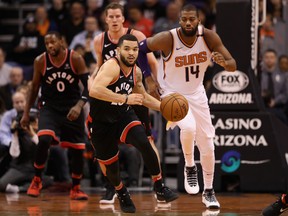 Raptors point guard Fred VanVleet moves the ball upcourt ahead of Suns forwad Greg Monroe during last night’s game in Phoenix at Talking Stick Resort Arena. (GETTY IMAGES)