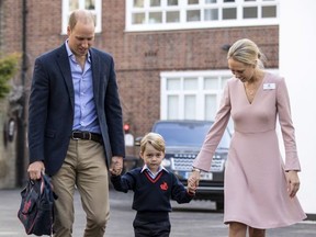 Prince George of Cambridge arrives for his first day of school with his father Prince William, Duke of Cambridge as they are met Head of the lower school Helen Haslem at Thomas's Battersea on September 7, 2017 in London, England.