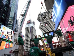 Workers unload the numerals 1 and 8 as they arrive in Times Square ahead of the New Year's Eve celebration, arrive in Times Square, December 13, 2017 in New York City.