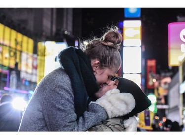 Jason McNally and Helena Rothe share a kiss in Times Square ahead of the New Year's Eve celebration on December 31, 2017 in New York City.