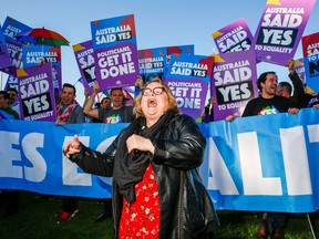 Magda Szubanski dances in front of equality ambassadors and volunteers from the Equality Campaign gathering in front of Parliament House in Canberra on December 7, 2017, ahead of the parliamentary vote on Same Sex Marriage.
