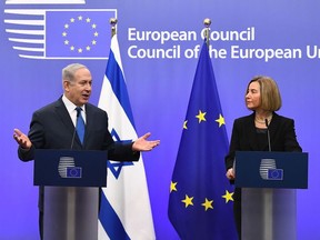 Israel's Prime Minister Benjamin Netanyahu speaks as EU foreign policy chief, Federica Mogherini looks on during a joint press conference at the European Council in Brussels on December 11, 2017.
