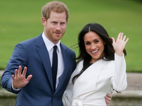 This file photo taken on November 27, 2017 shows Britain's Prince Harry and his fiancée US actress Meghan Markle posing for a photograph in the Sunken Garden at Kensington Palace in west London following the announcement of their engagement. Meghan Markle is to become the first fiancee invited to spend Christmas with the British royal family -- a move hailed December 14, 2017, as a sea change in the monarchy's traditionalist attitude.  (DANIEL LEAL-OLIVAS/AFP/Getty Images)