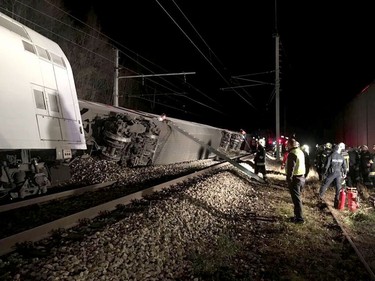 This handout photo made available by the Lower Austrian Fire Department shows members of the emergency services working at the scene when two passenger trains collided causing several carriages to derail in Kritzendorf, Lower Austria on Dec. 22, 2017. (APA AND LOWER AUSTRIAN FIRE DEPARTMENT/AFP/Getty Images/HO)