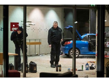 Police officers inspect damage in the lobby of the German Social Democratic Party  headquarters after a car was used to ram the building early Dec. 25, 2017.  (ODD ANDERSEN/AFP/Getty Images)