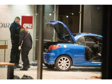 Police officers inspect damage in the lobby of the German Social Democratic Party  headquarters after a car was used to ram the building early Dec. 25, 2017.  (ODD ANDERSEN/AFP/Getty Images)