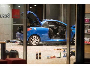 Petrol and lighter fluid canisters are seen next to a car in the lobby of the German Social Democratic Party headquarters after a vehicle was used to ram the building in Berlin early Dec. 25, 2017.  (ODD ANDERSEN/AFP/Getty Images)