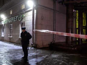 A police officer cordons off the site of a blast in a supermarket in Saint Petersburg on December 27, 2017.