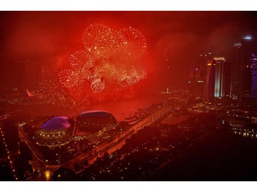 Fireworks illuminate the skyline as the clock strikes midnight during New Year's Eve celebrations in Singapore early on January 1, 2018.