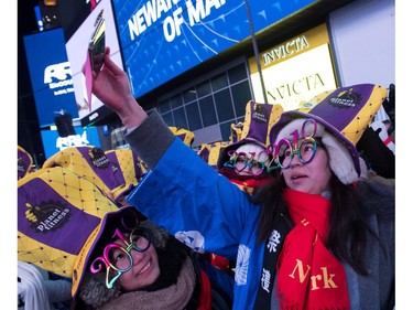 Revelers take photos as they wait for New Year's Eve celebrations in Times Square on December 31, 2017 in New York.