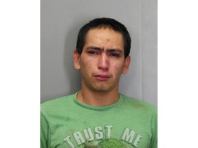 This December 2017 photo released by the Official Fairfax County Police Department shows Wilmer Lara Garcia, wearing a T-shirt emblazoned with "Trust Me", who was charged with auto theft and two counts of forgery after allegedly stealing a car with an accomplice in Fairfax County, Va. (Official Fairfax County Police Department via AP)

 Edit  Download Toggle Button MenuBackPrevNextClose