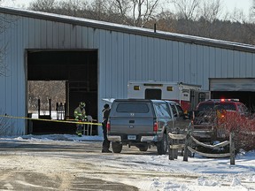 Fire officials investigate the cause of a fire at Folly Farm in Simsbury, Conn., Thursday, Dec. 28, 2017. The owners of the Connecticut equestrian training and boarding farm said many horses died in the fire at their barn. (John Woike/Hartford Courant via AP)