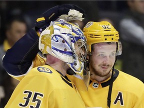 Predators' centre Ryan Johansen congratulates hot goalie Pekka Rinne after Nashville beat the Chicago Blackhawks 3-2 on Tuesday in NHL action in Nashville, Tenn.