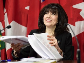 Ontario auditor general Bonnie Lysyk packs the pages of her annual report as she prepares to leave a news conference in Toronto, Wednesday, Dec. 6, 2017. THE CANADIAN PRESS/Frank Gunn