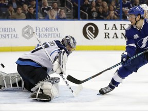 Tampa Bay Lightning center Brayden Point (21) flips the puck past Winnipeg Jets goalie Connor Hellebuyck (37) for a goal during overtime in an NHL hockey game Saturday, Dec. 9, 2017, in Tampa, Fla. The Lightning won 4-3. (AP Photo/Chris O'Meara)