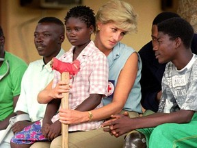 In this Jan. 14, 1997 file photo, Diana, Princess of Wales, talks to amputees, at the the Neves Bendinha Orthopedic Workshop on the outskirts of Luanda, Angola. Kensington Palace says Princes William and Harry have chosen sculptor Ian Rank-Broadley to create a statute of their mother, Princess Diana, to mark the 20th anniversary of her death.