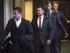 Simon Radford, Joshua Finbow and Craig Stoner, left to right, British sailors charged with sexual assault causing bodily harm while visiting for a hockey tournament earlier in the year, follow lawyer Geoff Newton from Nova Scotia Supreme Court in Halifax on August 12, 2015. The case of four British sailors charged with sexually assaulting a young woman at a military base in Halifax is due in court today.A preliminary hearing is scheduled for Simon Radford, Joshua Finbow, Craig Stoner and Darren Smalley, who are all facing a charge of sexual assault causing bodily harm.
