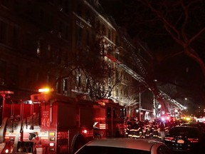 Firefighters respond to a building fire Thursday, Dec. 28, 2017, in the Bronx borough of New York.