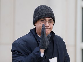 Manuel Burga waves to reporters as he leaves federal court in the Brooklyn borough of New York, Tuesday, Dec. 26, 2017.  (AP Photo/Seth Wenig)