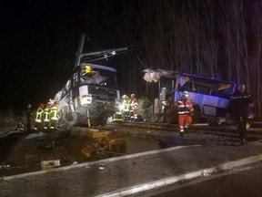 In this photo provided by France Bleu, rescue workers help after a school bus and a regional train collided in the village of Millas, southern France, Thursday, Dec. 14, 2017. A school bus and a regional train collided in southern France on Thursday, killing four children and critically injuring several other people on the bus, the French interior ministry said. (Matthieu Ferri/France Bleu via AP)