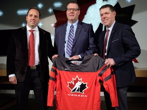 Hockey Canada president Scott Smith, right, senior manager Shawn Bullock, left, and head scout Brad McEwen, after announcing Canada's selection camp roster on Dec. 6, 2017