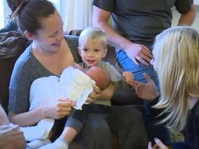 Nurse Katie Michael of Mechanicsburg, Pa. holds baby Ella Katherine after delivering the newborn herself outside her hospital.