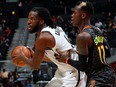 Dennis Schroder of the Atlanta Hawks defends against DeMarre Carroll of the Brooklyn Nets at Philips Arena on Dec. 4, 2017