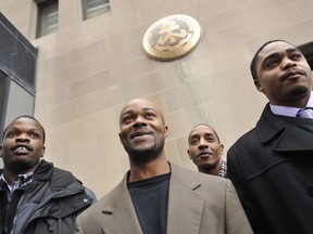 In this Jan. 17, 2012 file photo, Harold Richardson, left, Vincent Thames, second from left, Terrill Swift, and Michael Saunders, right, pose for a photo after a hearing in Chicago for the four men known as "the Englewood Four," whose 1994 rape and murder convictions were overturned in November 2011. The Chicago City Council approved Wednesday, Dec. 13, 2017, a $31 million settlement to be shared by the men who each spent more than a decade in prison.
