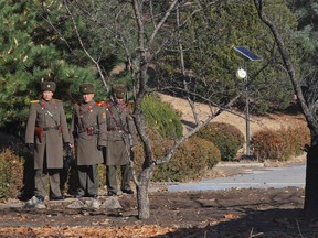 This file photo taken on November 27, 2017 shows North Korean soldiers staring at the South side at the truce village of Panmunjom in the Demilitarized zone (DMZ) dividing the two Koreas.