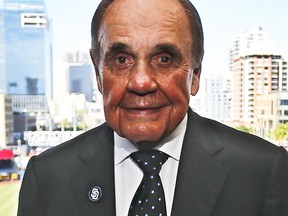 In this Sept. 29, 2016, file photo, Dick Enberg, the voice of the San Diego Padres, poses in his booth prior to the Padres' final home baseball game of the season in San Diego.  (AP Photo/Lenny Ignelzi, File)