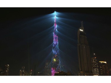 An LED light show illuminates the Burj Khalifa, the world's tallest building, to celebrate the New Year in Dubai, United Arab Emirates, Monday, Jan. 1, 2018.