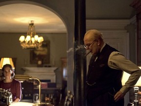 This image released by Focus Features shows Lily James as Elizabeth Layton, left, and Gary Oldman as Winston Churchill in a scene from "Darkest Hour." (Jack English/Focus Features via AP)
