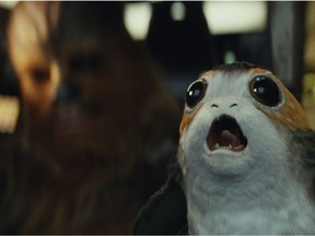 This image released by Lucasfilm shows Chewbacca, left, and a Porg in a scene from "Star Wars: The Last Jedi." (Lucasfilm via AP)