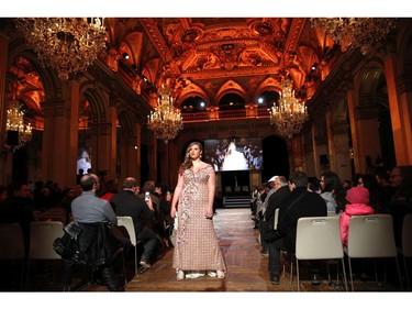 A plus-size model presents a creation during a fashion show as part of a day against fat phobia in Paris, France, Friday, Dec. 15, 2017.