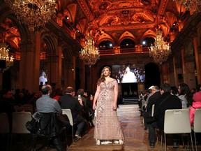 A plus-size model presents a creation during a fashion show as part of a day against fat phobia in Paris, France, Friday, Dec. 15, 2017.