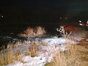 In this Monday, Dec. 25, 2017 photo provided by the Washington County Sheriffs Office, a search and rescue team work on the edge of a frozen pond in the town of New Harmony, north of St. George, Utah. A sheriff's deputy in southern Utah punched through the frozen pond on Christmas Day to rescue drowning 8-year-old boy. Washington County sheriff's Lt. David Crouse said the boy was chasing his dog Monday evening when another child saw him fall through the ice. (Washington County Sheriffs Office via AP)