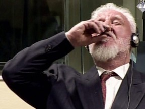 This videograb taken from live footage of the International Criminal Court, shows Croatian former general Slobodan Praljak swallowing what is believed to be poison, during his judgement at the UN war crimes court to protest the upholding of a 20-year jail term.