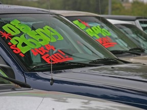 In this stock photo, used SUVs sit on a dealer lot.