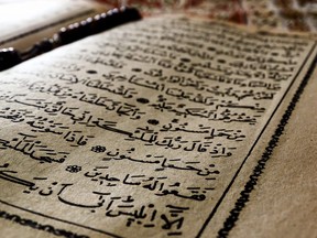 In this stock photo, the Muslim holy book Quran sits open on a rug.