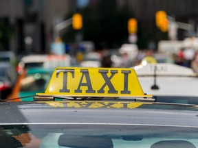 In this stock photo, a taxi cab sits on a busy street in Toronto, Ont.
