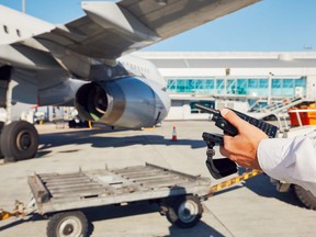 In this stock photo, airport ground staff prepare passenger airplane before flight.