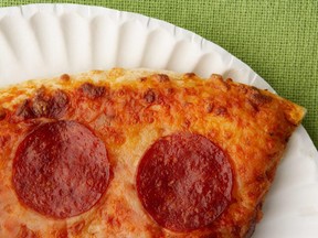 In this stock photo, a slice of pepperoni pizza sits on a paper plate.