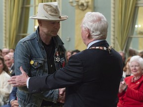 Governor General David Johnston shakes hands with Tragically Hip singer Gord Downie after investing him in the Order of Canada during a ceremony at Rideau Hall, Monday, June 19, 2017 in Ottawa.