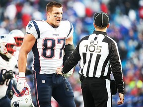 Rob Gronkowski #87 of the New England Patriots talks with back judge Dino Paganelli #105 during the fourth quarter against the Buffalo Bills on December 3, 2017 at New Era Field in Orchard Park, New York.  (Photo by Tom Szczerbowski/Getty Images)