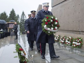 Halifax firefighters lay a wreath at a ceremony to mark the 100th anniversary of the Halifax Explosion at Fort Needham Memorial Park in Halifax on Wednesday, Dec. 6, 2017.