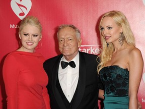 Hugh Hefner (centre) is seen with former Playboy Playmates Kristina (L) and Karissa Shannon in this 2012 file photo.  (Jason Merritt/Getty Images)