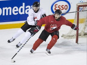 Canadian national junior team prospects Cody Glass, left, and Victor Mete battle for the puck on the first day of selection camp for the 2018 world junior hockey championship in St. Catharines, Ont., on Tuesday, Dec. 12, 2017.