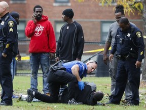 Police respond to a crime scene after an assailant fired multiple rounds into a park and playground, wounding at least one, before feeling the area, Thursday, Nov. 2, 2017, in Cincinnati.