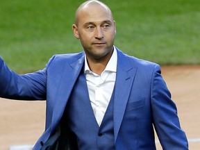 In this May 14, 2017, file photo, former New York Yankees player Derek Jeter waves to fans during a ceremony retiring his number